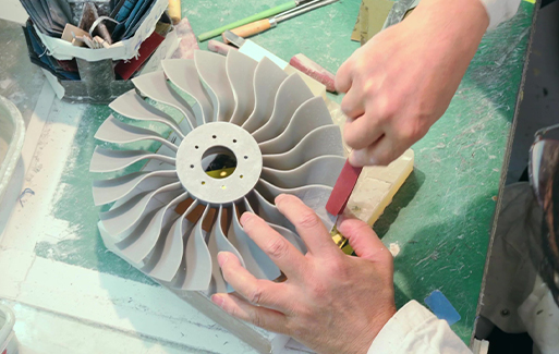 Hands seen sanding grey 3d printed fan blade