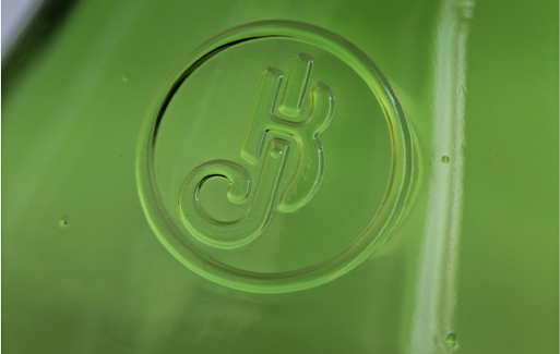 Close up of logo on green bottle