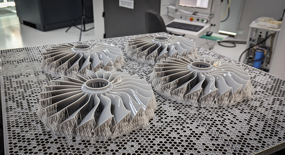 Four 3D Printed Fan Blades in Grey sitting on print bed