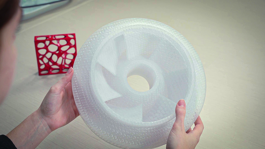 Hands holding round fan like 3d printed part